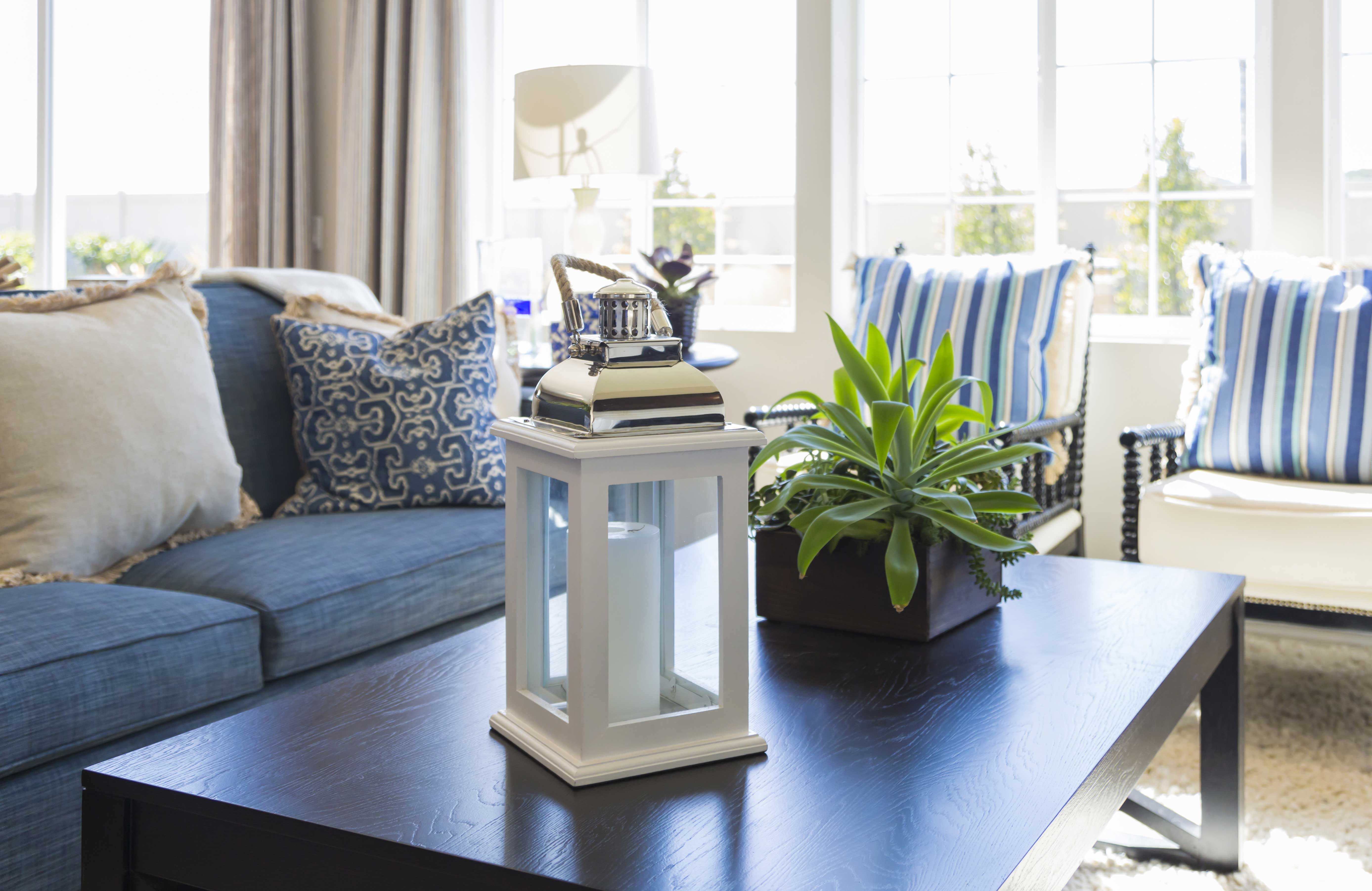 open-airy-living-room-a-beautiful-couch-and-a-coffee-table-with-a-lantern-on-it